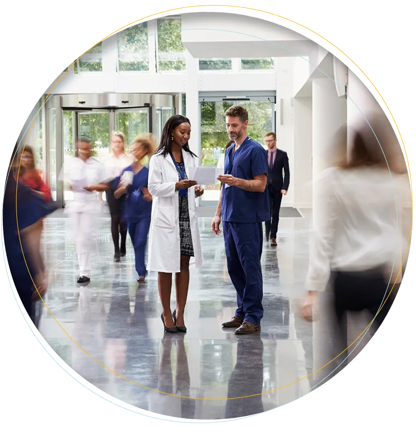 A woman doctor has a sheet in her hand explaining the processes to her supervisor