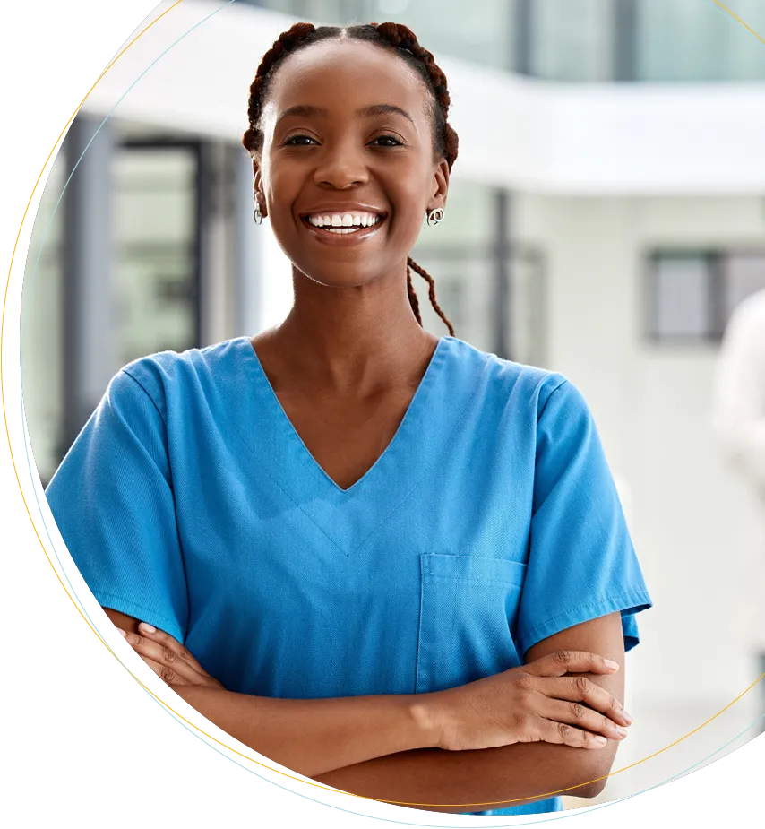 a female doctor smiling with her arms crossed